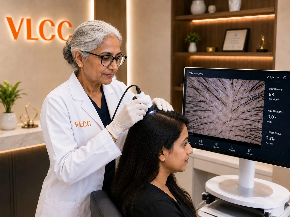 VLCC dermatologist performing a trichoscopy scalp analysis on a female client