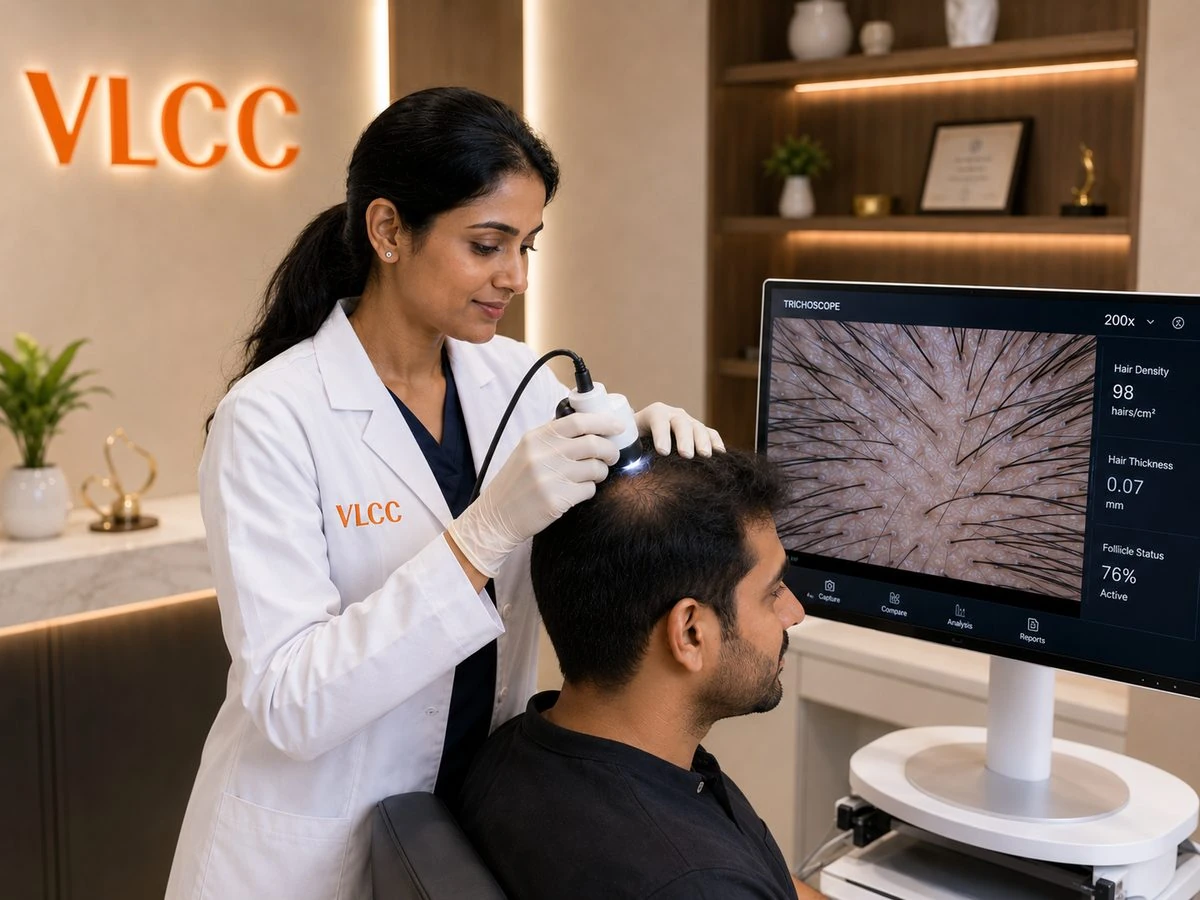 VLCC dermatologist performing a video-dermatoscope scalp analysis on a male client